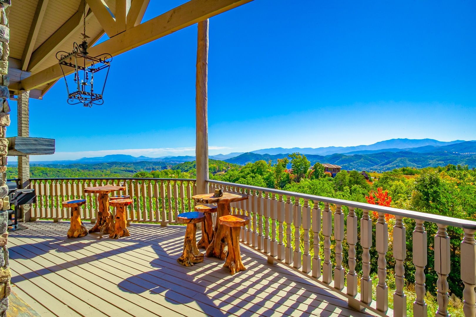 Covered lodge deck with wooden tables and sweeping Smoky Mountain views