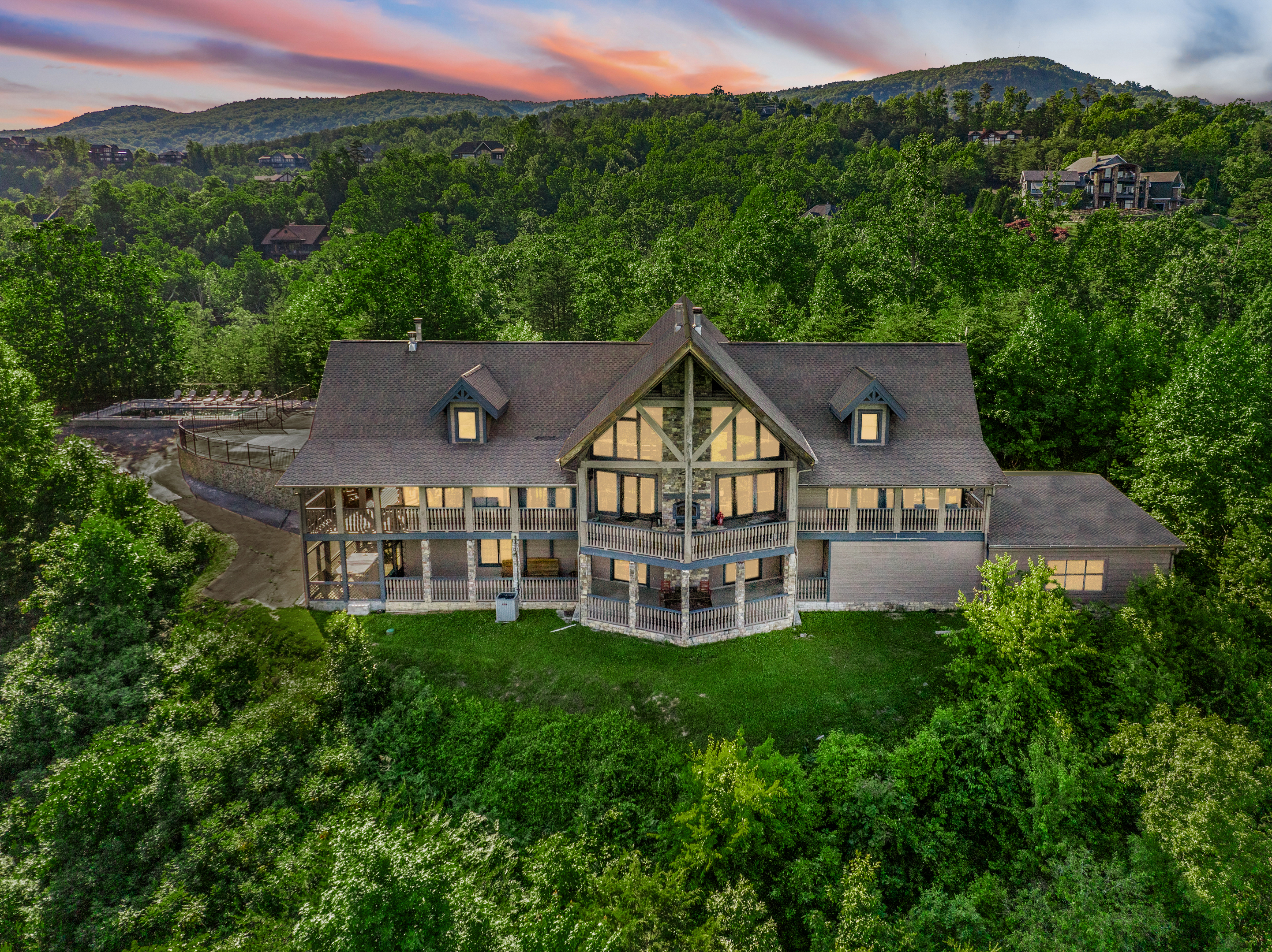 Majestica Lodge surrounded by wooded Smoky Mountain hills at sunset